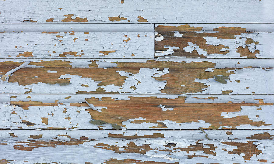 Cracking and peeling lead paint off of wood sliding.